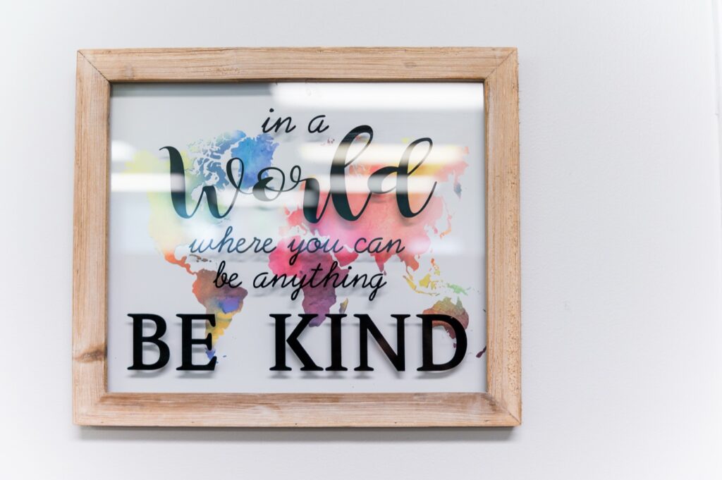 "Be Kind" sign on the wall of the Our Konnection office